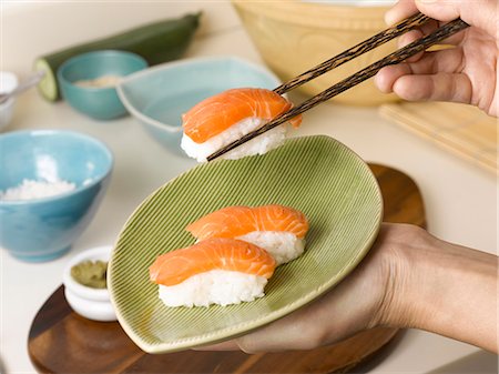 seafood and plate and overhead - Woman holding plate of sushi Stock Photo - Premium Royalty-Free, Code: 649-05656777