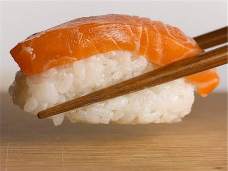 sushi - Close up of chopsticks holding sushi Foto de stock - Sin royalties Premium, Código: 649-05656778