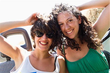 sunglasses - Women smiling together in convertible Stock Photo - Premium Royalty-Free, Code: 649-05656818