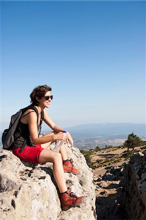 people with backpack - Hiker resting on rocks on hill Stock Photo - Premium Royalty-Free, Code: 649-05656852