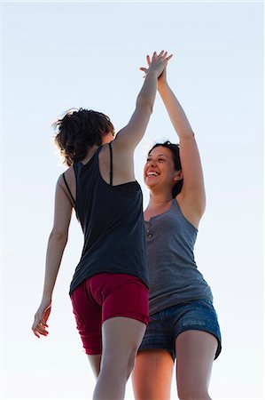 Women high-fiving outdoors Stock Photo - Premium Royalty-Free, Code: 649-05656869