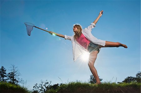 Woman using butterfly net outdoors Stock Photo - Premium Royalty-Free, Code: 649-05656929