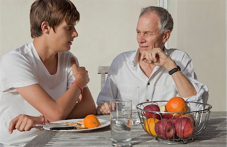 pictures of family at dinner table - Father and son eating fruit outdoors Stock Photo - Premium Royalty-Free, Code: 649-05656972