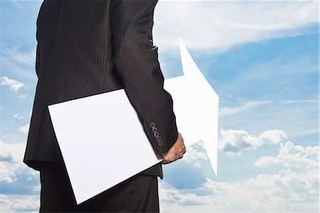 Businessman holding blank arrow Stock Photo - Premium Royalty-Free, Code: 649-05657055