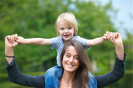 portrait of woman bonding with child - Mother carrying son on her shoulders Stock Photo - Premium Royalty-Free, Code: 649-05657091