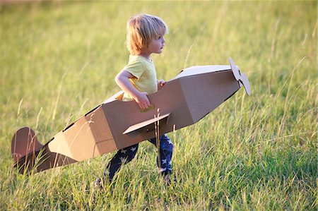 europe aeroplane - Boy flying airplane outdoors Stock Photo - Premium Royalty-Free, Code: 649-05657106