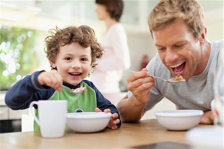 Father and son eating breakfast Stock Photo - Premium Royalty-Free, Code: 649-05657166
