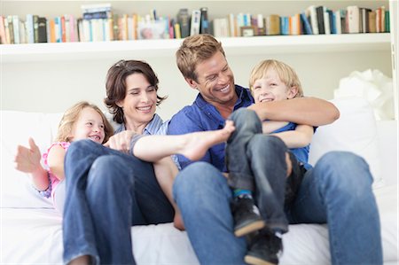 Family relaxing together on couch Stock Photo - Premium Royalty-Free, Code: 649-05657197