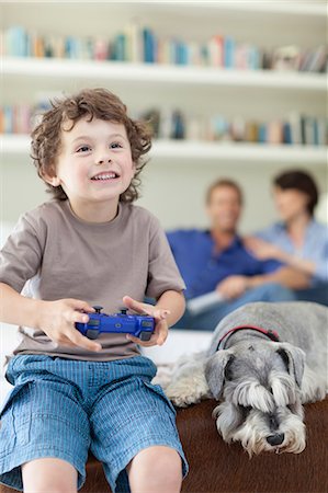 fun animals - Boy playing video games in living room Stock Photo - Premium Royalty-Free, Code: 649-05657201