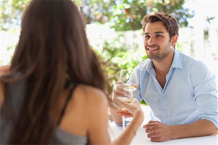 simsearch:6122-08229507,k - Couple having wine at table outdoors Fotografie stock - Premium Royalty-Free, Codice: 649-05657363