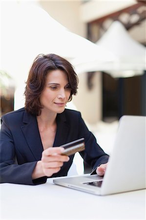shop online card - Businesswoman shopping online outdoors Stock Photo - Premium Royalty-Free, Code: 649-05657425