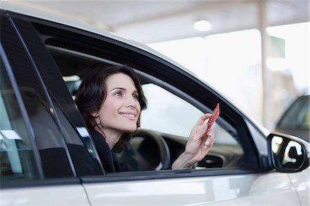 shopping auto - Woman paying with credit card Stock Photo - Premium Royalty-Free, Code: 649-05657446