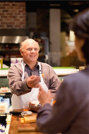 Man with free samples in grocery store Stock Photo - Premium Royalty-Free, Code: 649-05657469