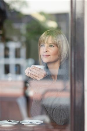 people drinking coffee at cafe - Woman having cup of coffee in cafe Stock Photo - Premium Royalty-Free, Code: 649-05657518