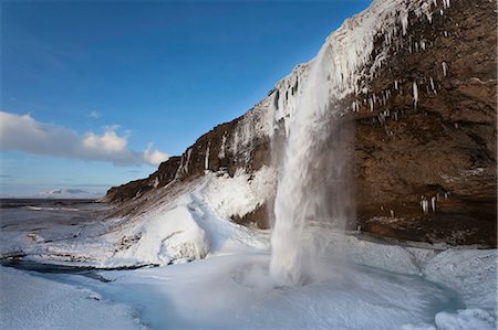 snow covered cliff - Glacial waterfall pouring into ice Stock Photo - Premium Royalty-Free, Code: 649-05657638