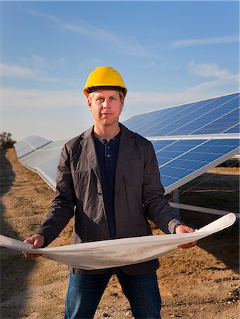 solar, energy - Architect with solar panels blueprints Stock Photo - Premium Royalty-Free, Code: 649-05657727