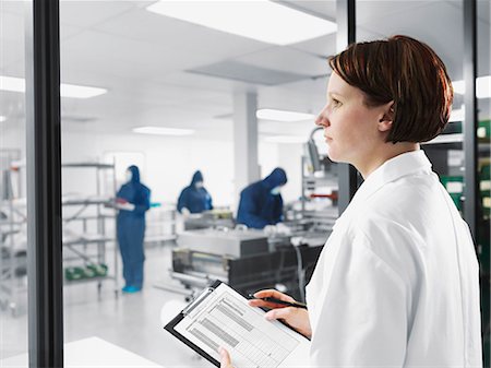 full body image of person in lab coat - Scientist using clipboard in lab Stock Photo - Premium Royalty-Free, Code: 649-05657755