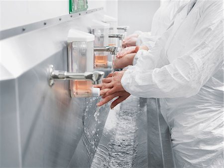 Scientists washing their hands in sink Stock Photo - Premium Royalty-Free, Code: 649-05657758