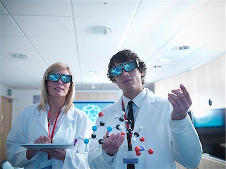 Scientists wearing 3D glasses in lab Stock Photo - Premium Royalty-Free, Code: 649-05658033
