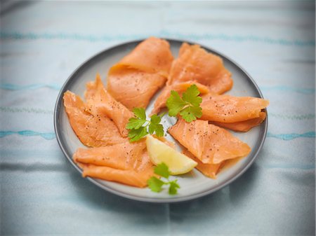 salmon top view - Close up of plate of salmon and lemons Stock Photo - Premium Royalty-Free, Code: 649-05658070
