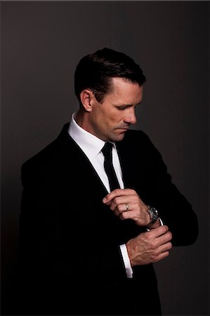 fashion elegant - Businessman adjusting his cuffs Stock Photo - Premium Royalty-Free, Code: 649-05658211