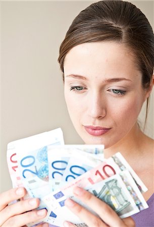 Woman counting Euro bills Stock Photo - Premium Royalty-Free, Code: 649-05658254