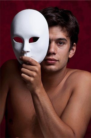 Nude man holding mask Stock Photo - Premium Royalty-Free, Code: 649-05658396