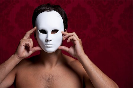 red background pic men - Nude man holding mask over his face Stock Photo - Premium Royalty-Free, Code: 649-05658397