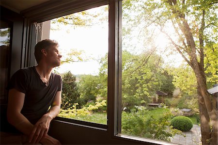 daydreaming (eyes open) - Man admiring landscape from window Stock Photo - Premium Royalty-Free, Code: 649-05801058