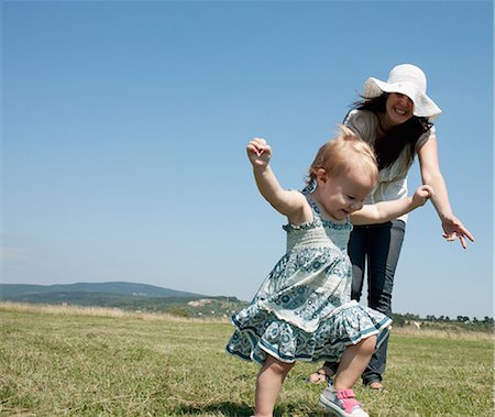 energetic woman walking - Mother and daughter walking in field Stock Photo - Premium Royalty-Free, Code: 649-05801241