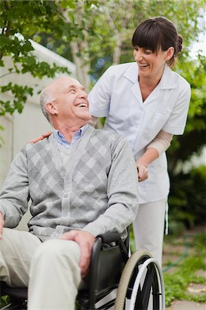 patient happy - Nurse wheeling older patient outdoors Stock Photo - Premium Royalty-Free, Code: 649-05801277