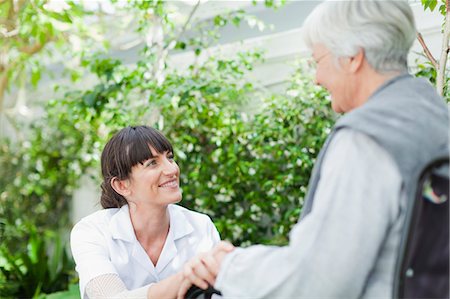 disability, work - Nurse talking to older patient outdoors Stock Photo - Premium Royalty-Free, Code: 649-05801279