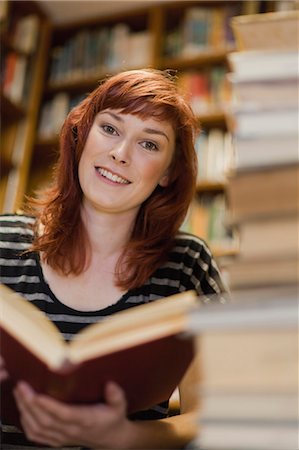 Student reading books in library Stock Photo - Premium Royalty-Free, Code: 649-05801361