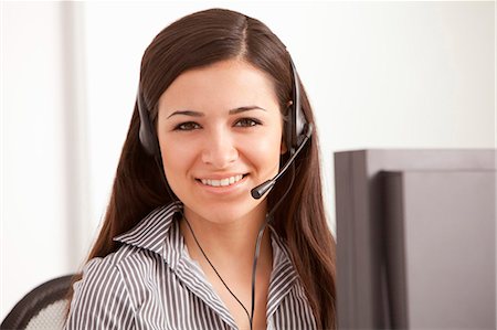 respond - Businesswoman talking on headset at desk Stock Photo - Premium Royalty-Free, Code: 649-05802053