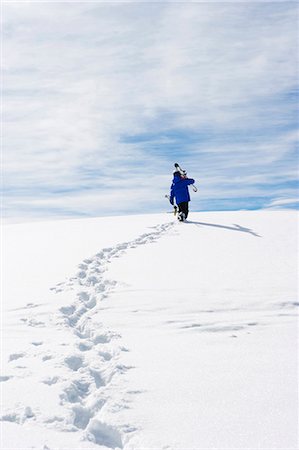 foot prints snow - Child carrying skis up snowy mountain Stock Photo - Premium Royalty-Free, Code: 649-05819580