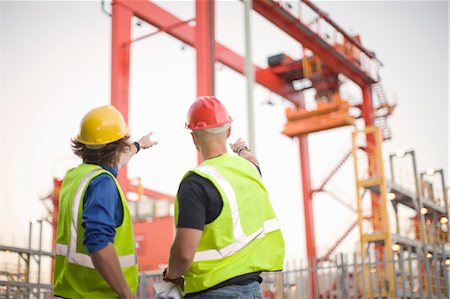 safety worker open arm - Construction workers talking on site Stock Photo - Premium Royalty-Free, Code: 649-05819747