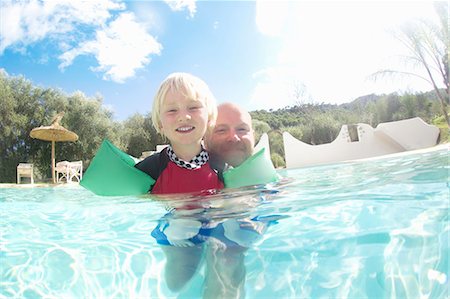 property release - Father and son playing in pool Stock Photo - Premium Royalty-Free, Code: 649-05819767