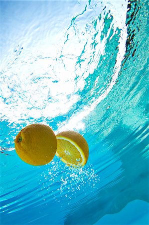 swimming pool still life nobody - Lemon floating in swimming pool Stock Photo - Premium Royalty-Free, Code: 649-05819769