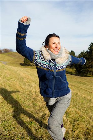 simsearch:649-06352629,k - Woman in parka running in field Stock Photo - Premium Royalty-Free, Code: 649-05819780