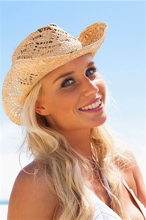 pretty women in bathing suits - Smiling woman wearing sunhat outdoors Stock Photo - Premium Royalty-Free, Code: 649-05820203