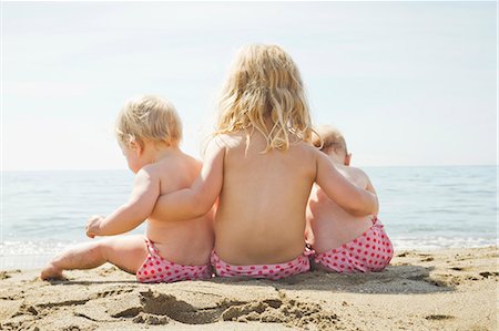 sitting beach - Children in matching bikini bottoms Stock Photo - Premium Royalty-Free, Code: 649-05820273