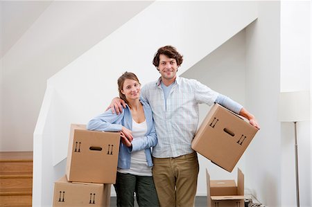 Couple carrying cardboard boxes Stock Photo - Premium Royalty-Free, Code: 649-05820559