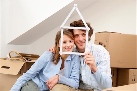 dreaming - Smiling couple holding house symbol Stock Photo - Premium Royalty-Free, Code: 649-05820553