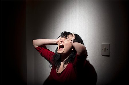 screaming woman in fear - Woman shouting indoors Stock Photo - Premium Royalty-Free, Code: 649-05820645