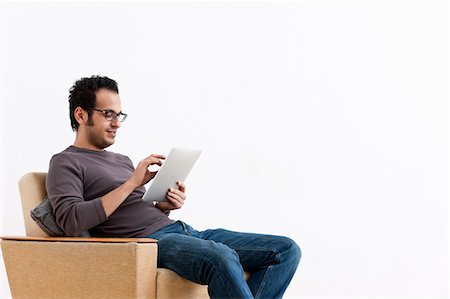 eyeglasses on white background - Smiling man using tablet computer Stock Photo - Premium Royalty-Free, Code: 649-05820794