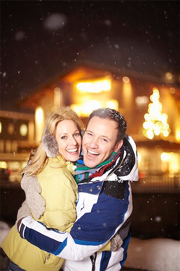 Smiling couple hugging in snow Stock Photo - Premium Royalty-Free, Image code: 649-05820999