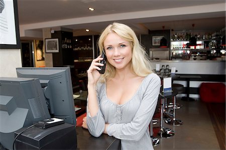 picture of cashier till - Hostess talking on phone in restaurant Stock Photo - Premium Royalty-Free, Code: 649-05949603