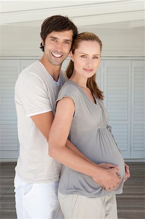 pregnant lady belly - Man holding pregnant girlfriends belly Foto de stock - Sin royalties Premium, Código: 649-05949740