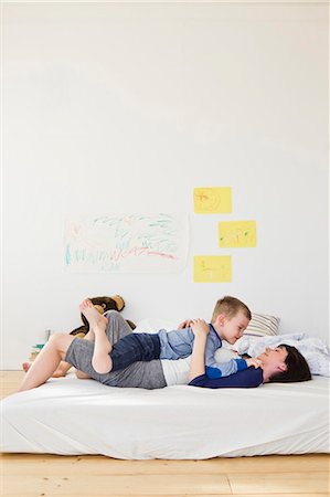 family laying in bed together - Mother and son relaxing on bed Stock Photo - Premium Royalty-Free, Code: 649-05949789