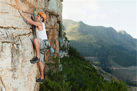 Climber scaling steep rock face Foto de stock - Sin royalties Premium, Código: 649-05949889